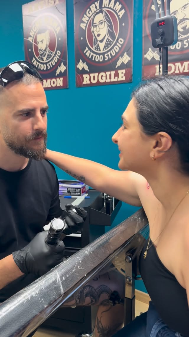 Damon tattooing at Angry Mama Tattoo Studio