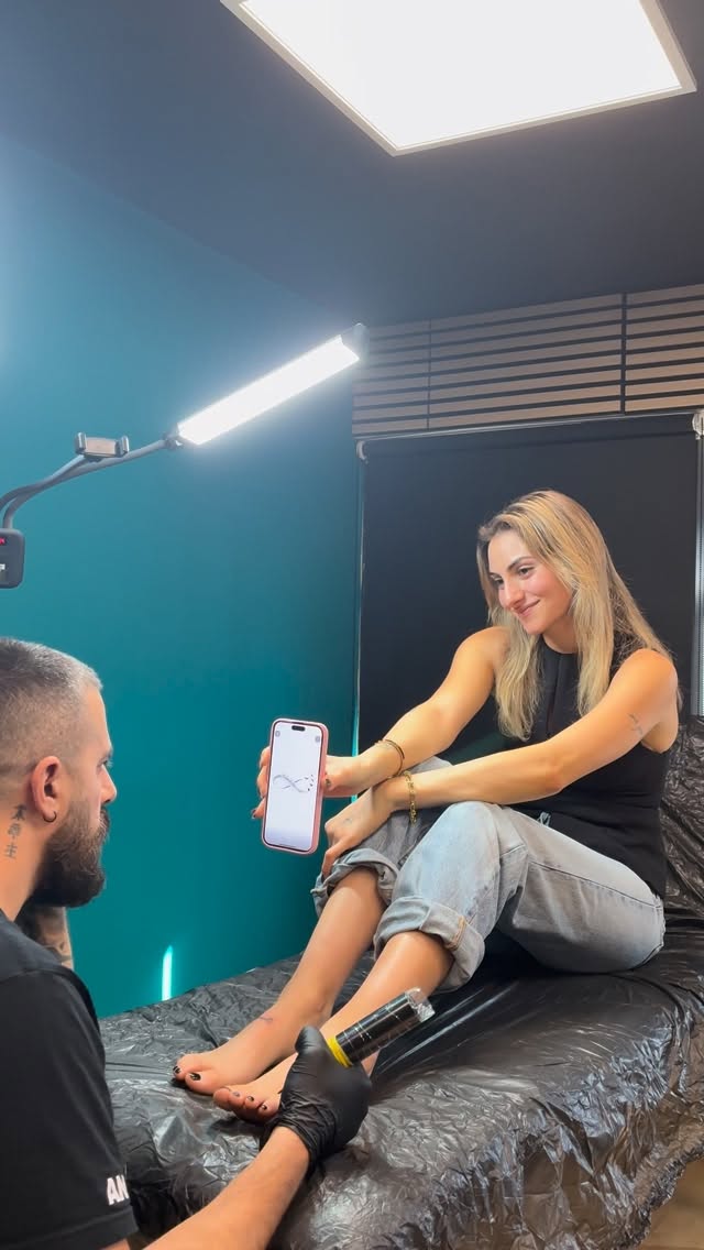 Alex consulting on a tattoo design