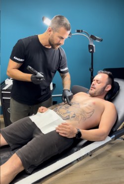 Alex tattooing at Angry Mama Tattoo Studio