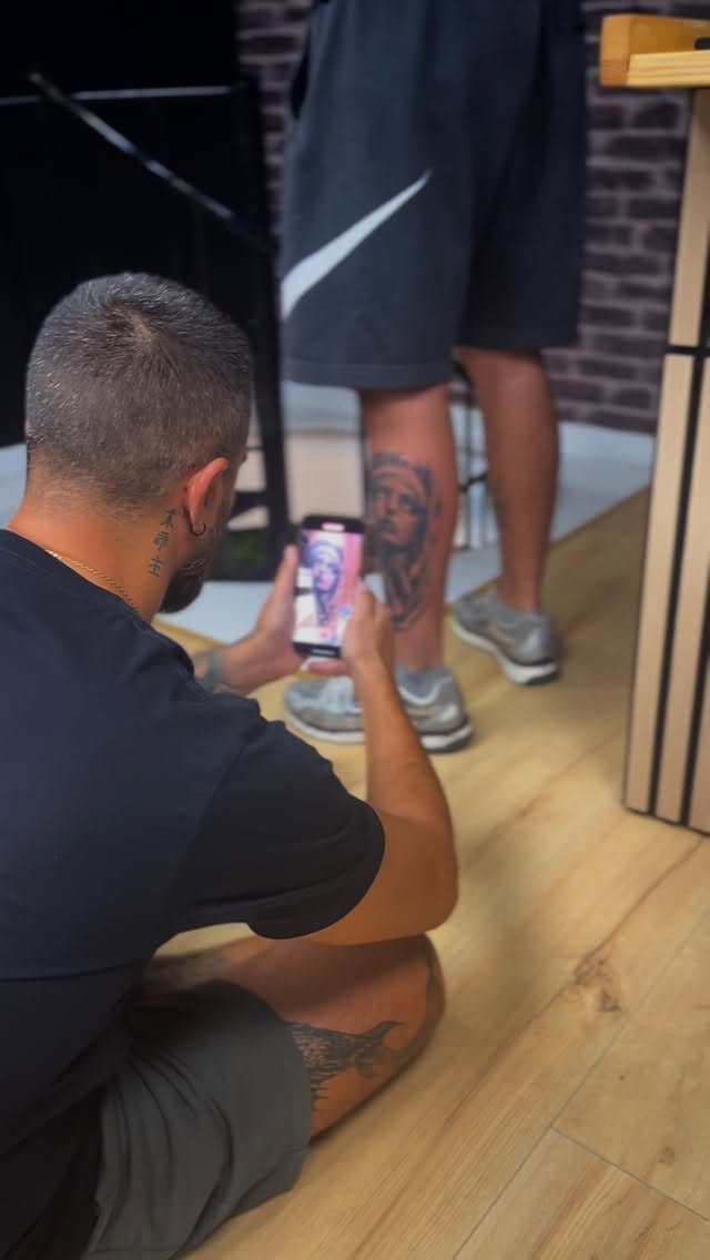 Artist photographing a finished tattoo — Angry Mama Tattoo Studio