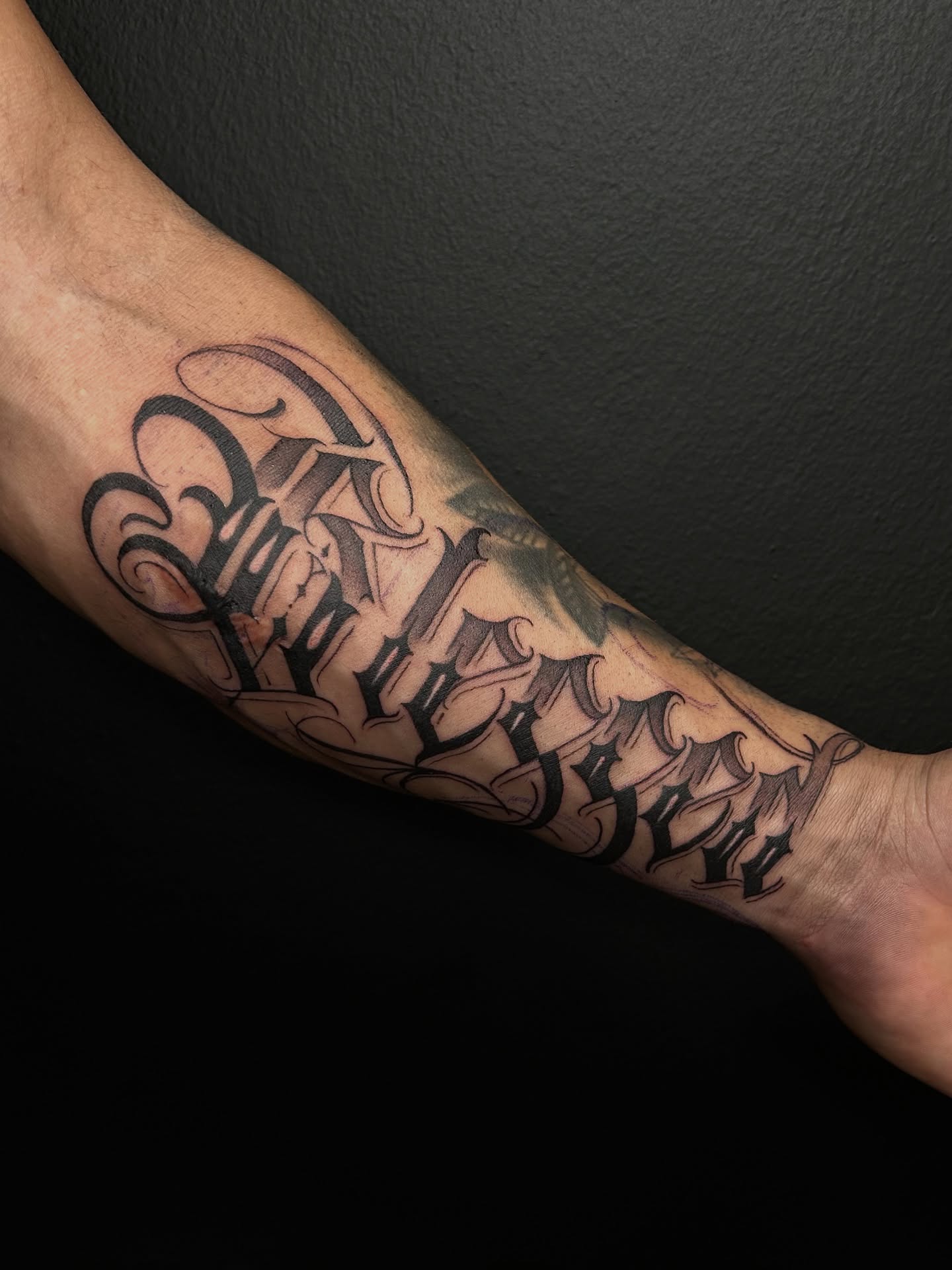 Gothic lettering tattoo