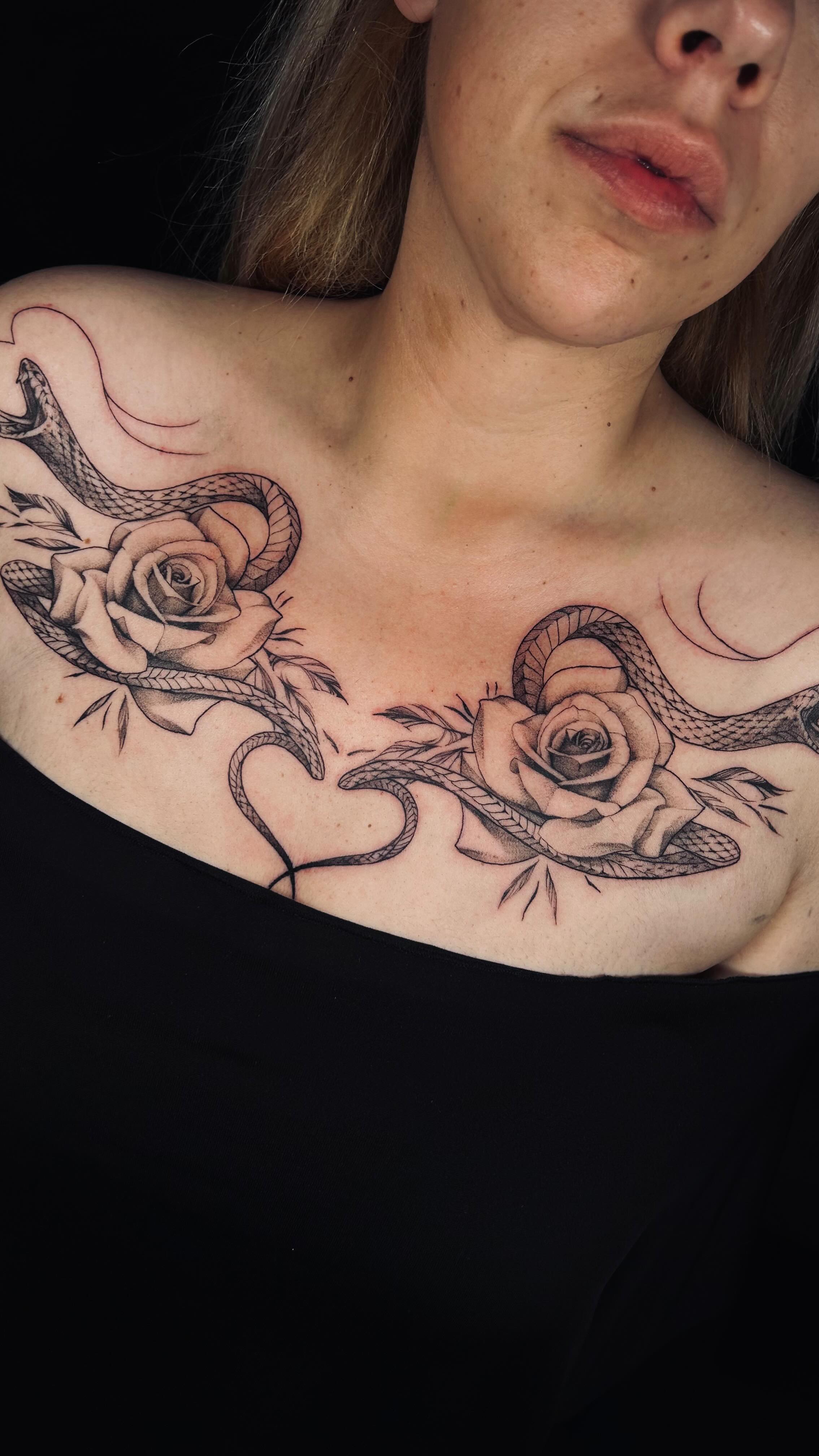 Roses and serpents chest tattoo